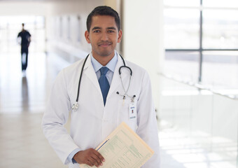 Doctor smiling in hospital hallway