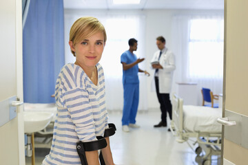 Patient using crutches in hospital room