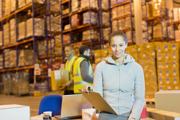 Worker holding clipboard in warehouse