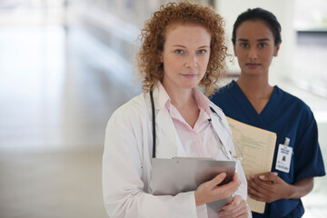 Fototapeta na wymiar Doctor and nurse standing in hallway