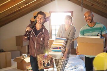 Friends unpacking boxes in attic - obrazy, fototapety, plakaty