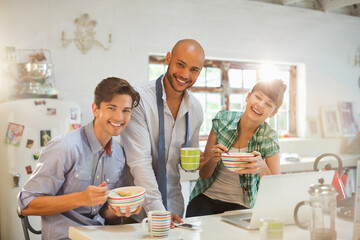 Friends having breakfast together in kitchen