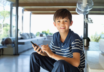 Boy using cell phone on steps