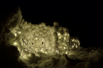 illuminated snowball wall in winter night