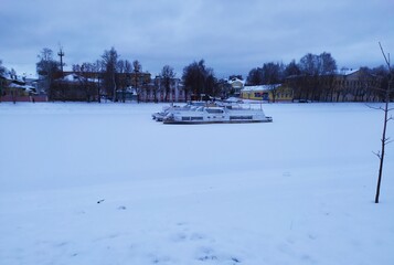 winter landscape with a frozen boat