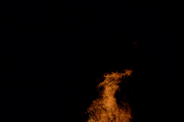 beautiful hot burning tall flames from bonfire on dark winter background