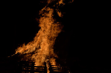 beautiful hot burning tall flames from bonfire on dark winter background