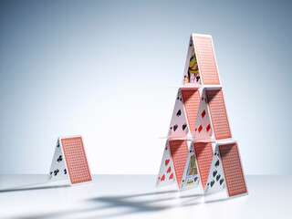 Small house of cards next to large house of cards