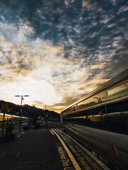 Train departing during sunrise