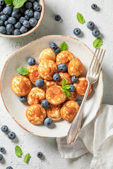 Delicious poffertjes with blueberries and mint leaves
