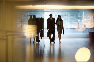 Businessman and businesswoman walking in lobby