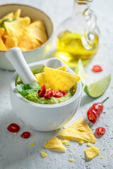 Traditional guacamole with tortilla, coriander and chilli peppers