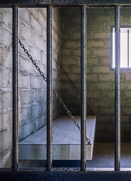 View of the prison cell through bars with sun shining through the window, 3d Render, 3d Illustration