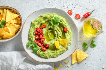 Enjoy your guacamole with tortilla, coriander and chilli peppers
