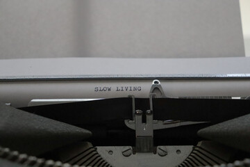 close up of an old typewriter with a message of slow living