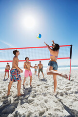 Friends playing beach volleyball