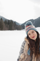 Fototapeta na wymiar Portrait of smiling woman in snowy field