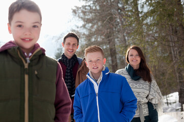 Portrait of smiling family in snowy woods