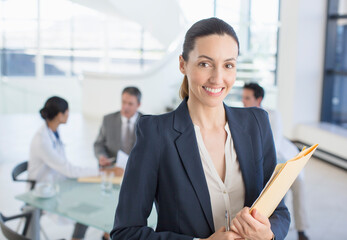 Portrait of smiling businesswoman in meeting with doctors