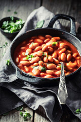Closeup of baked beans made of fresh tomatoes and herbs