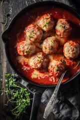 Top view of tasty meatballs with tomato sauce and cheese
