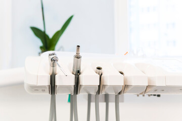 Close-up of a special professional equipment and tools in a dental office. Concepts of the dentist clinic or hospital, teeth and health care. Shallow depth of field