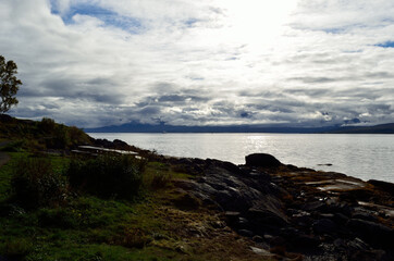 blue fjord, sunhine and thick clouds