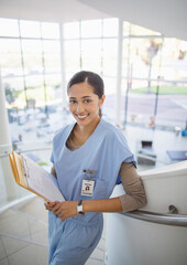 Portrait of smiling nurse on hospital staircase