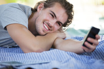 Man using cell phone on picnic blanket