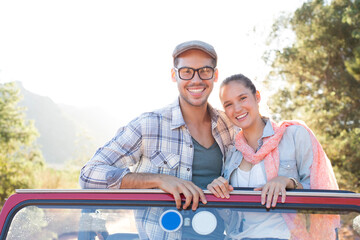 Portrait of smiling couple in sport utility vehicle