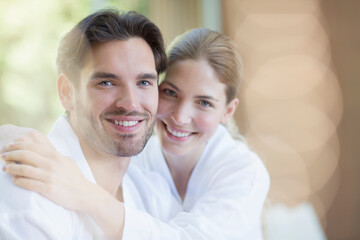 Obraz na płótnie Canvas Portrait of smiling couple in bathrobes