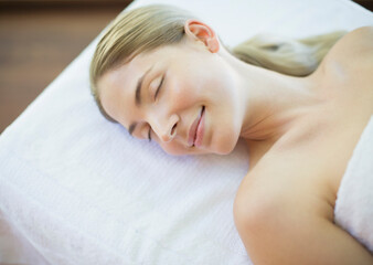 Serene woman laying on massage table