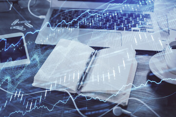 Multi exposure of financial graph drawings and desk with open notebook background. Concept of forex