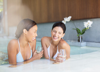 Women laughing in hot tub at spa
