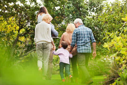 Multi-generation family walking in park