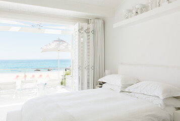 Modern bedroom overlooking beach and ocean - Powered by Adobe