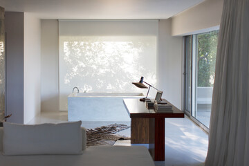 Desk and bathtub in modern house