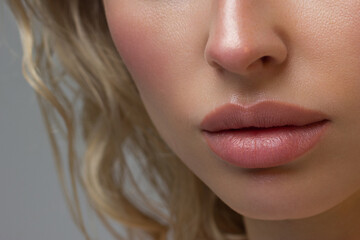 Close-up of woman's Lips with Fashion pink Make-up and Manicure on Nails. Beautiful female full lips with perfect Makeup. Part of female face. Macro shot of beautiful make up on full lips