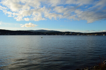 blue fjord and sun over tromsoe city island in late autumn
