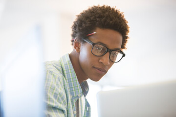 Businessman working at laptop in office