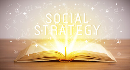 Open book with SOCIAL STRATEGY inscription, social media concept