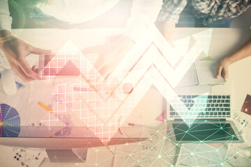 Fototapeta premium Double exposure of man and woman working together and arrows drawing. Computer background. Top View. Growth concept.