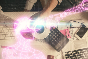 Double exposure of man and woman working together and man in virtual glasses hologram drawing. Computer background. Top View. VR, AR concept.