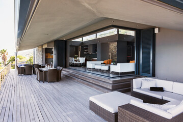 Sofa, tables and chairs on modern balcony