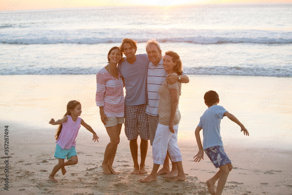 Poster multi-generation family hugging on beach