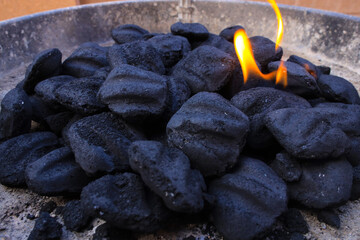charcoal bricks in grill catching fire
