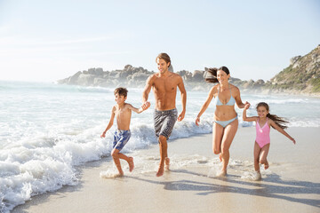 Family running together in waves