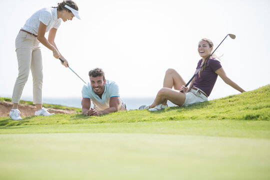 Friends Playing On Golf Course