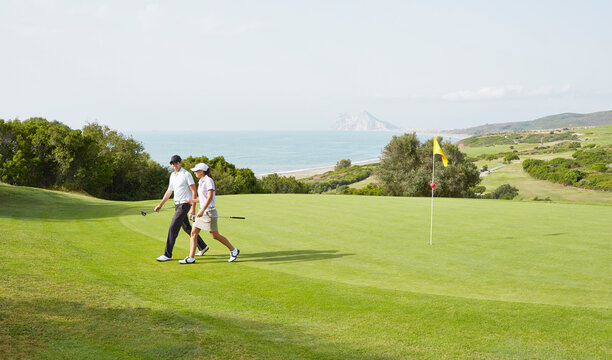 Couple walking on golf course