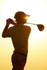 Fotobehang Silhouette of man swinging golf club © Chris Ryan/KOTO